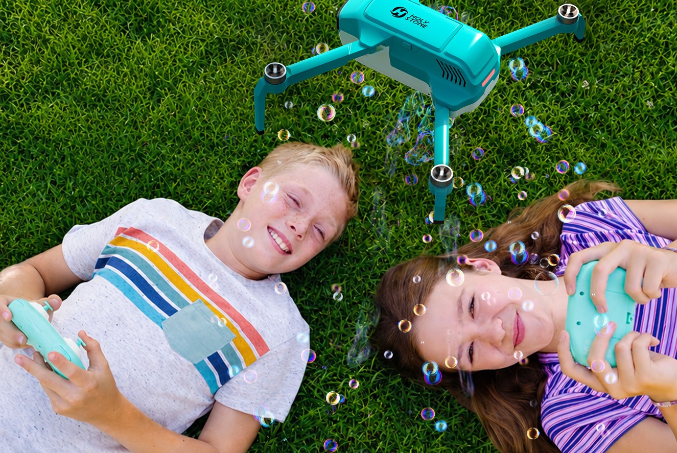 kids lying on grass with HS320 remote controllers.jpg